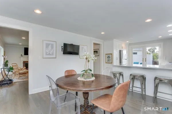 a view of a dining room with furniture and wooden floor