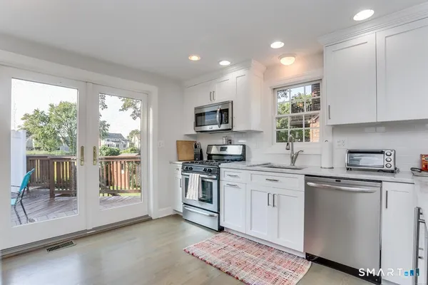 a kitchen with a sink stove top oven and refrigerator