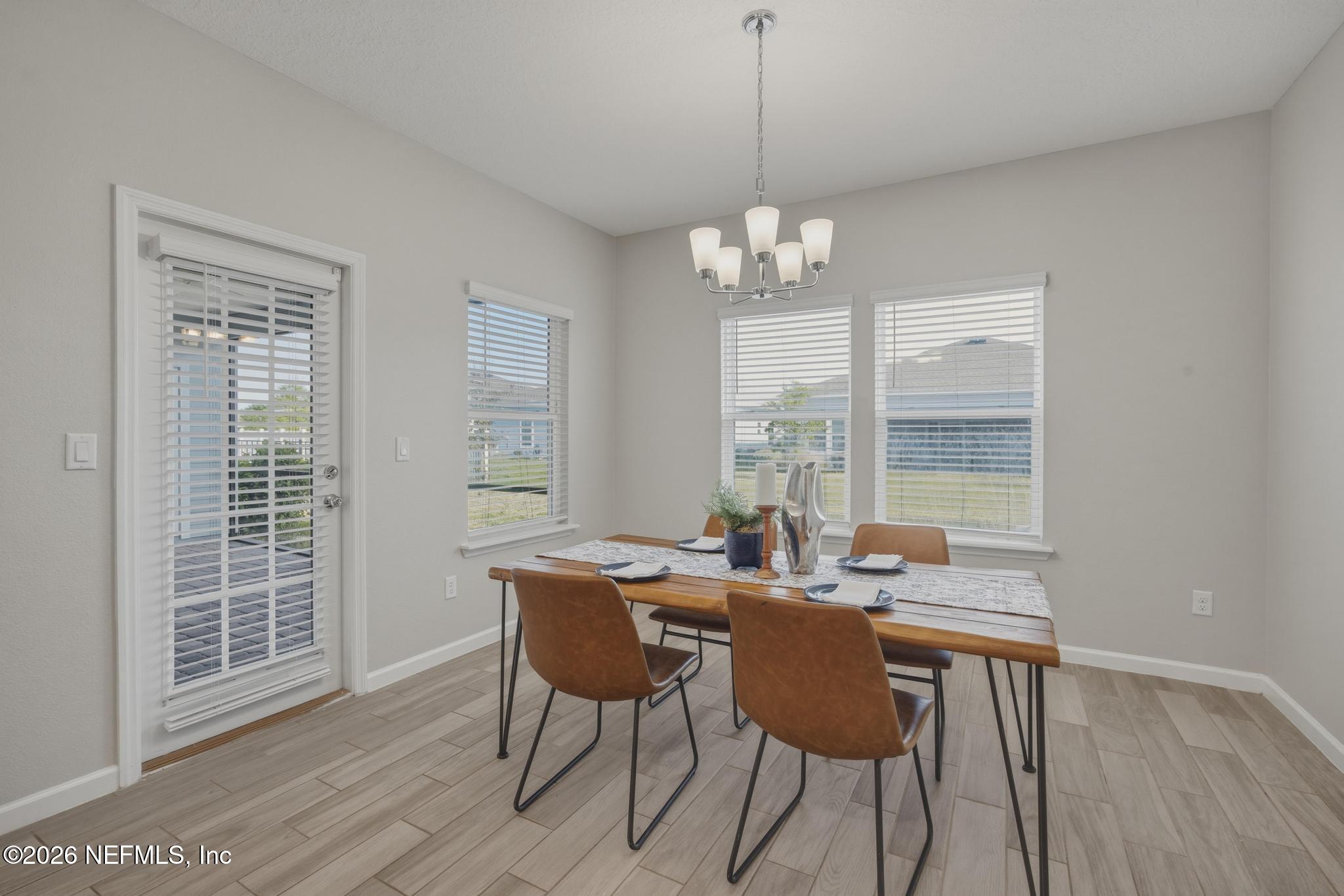 3841 Heatherbrook Place Middleburg, FL 32068 - Photo 15 of 39 a view of a dining room with furniture window and wooden floor