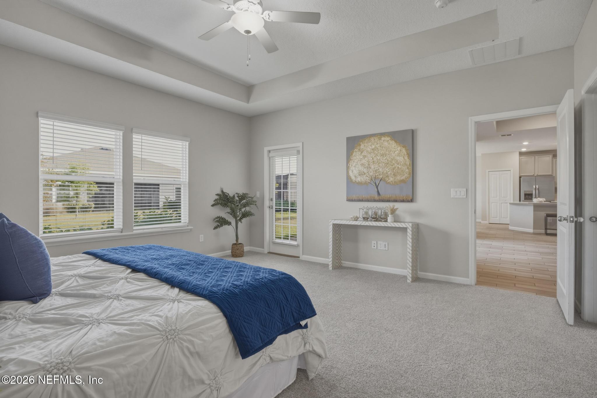 3841 Heatherbrook Place Middleburg, FL 32068 - Photo 18 of 39 a spacious bedroom with a large bed and a chandelier