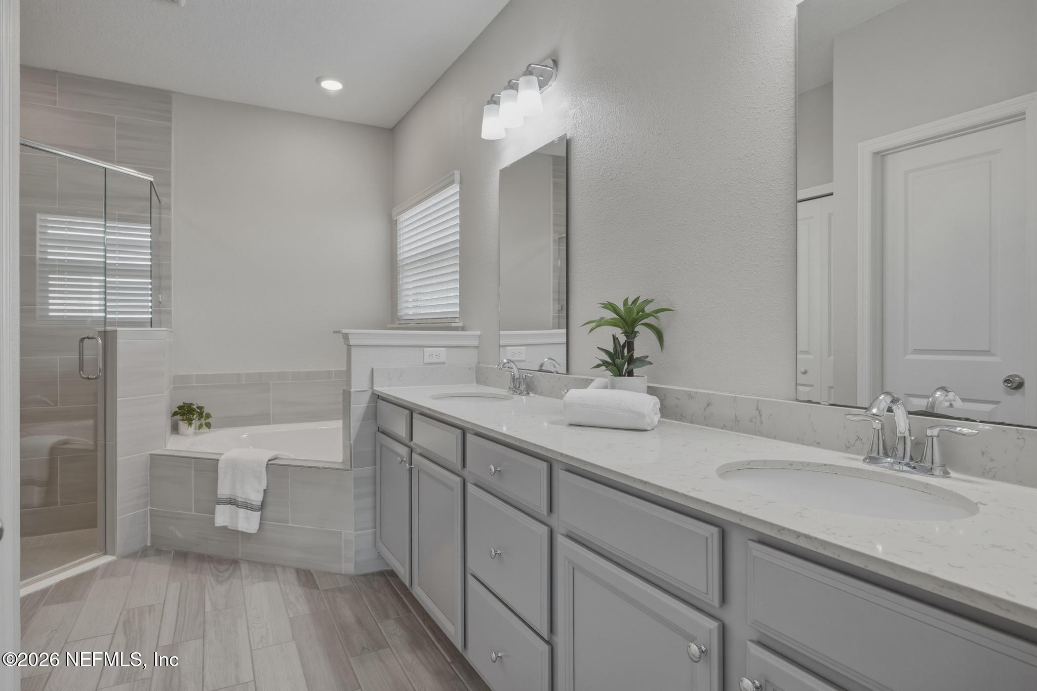 3841 Heatherbrook Place Middleburg, FL 32068 - Photo 19 of 39 a spacious bathroom with a granite countertop sink a toilet and shower