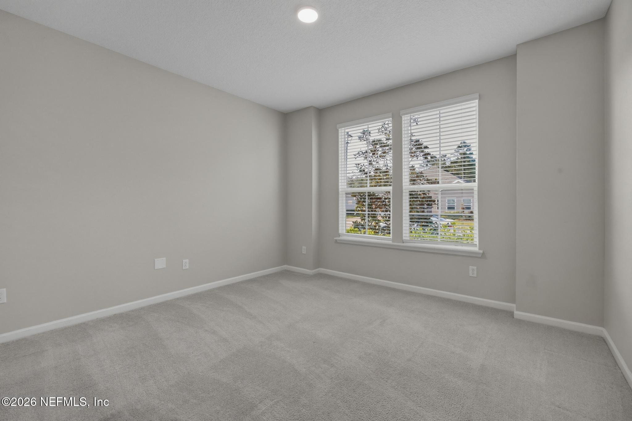 3841 Heatherbrook Place Middleburg, FL 32068 - Photo 22 of 39 an empty room with windows