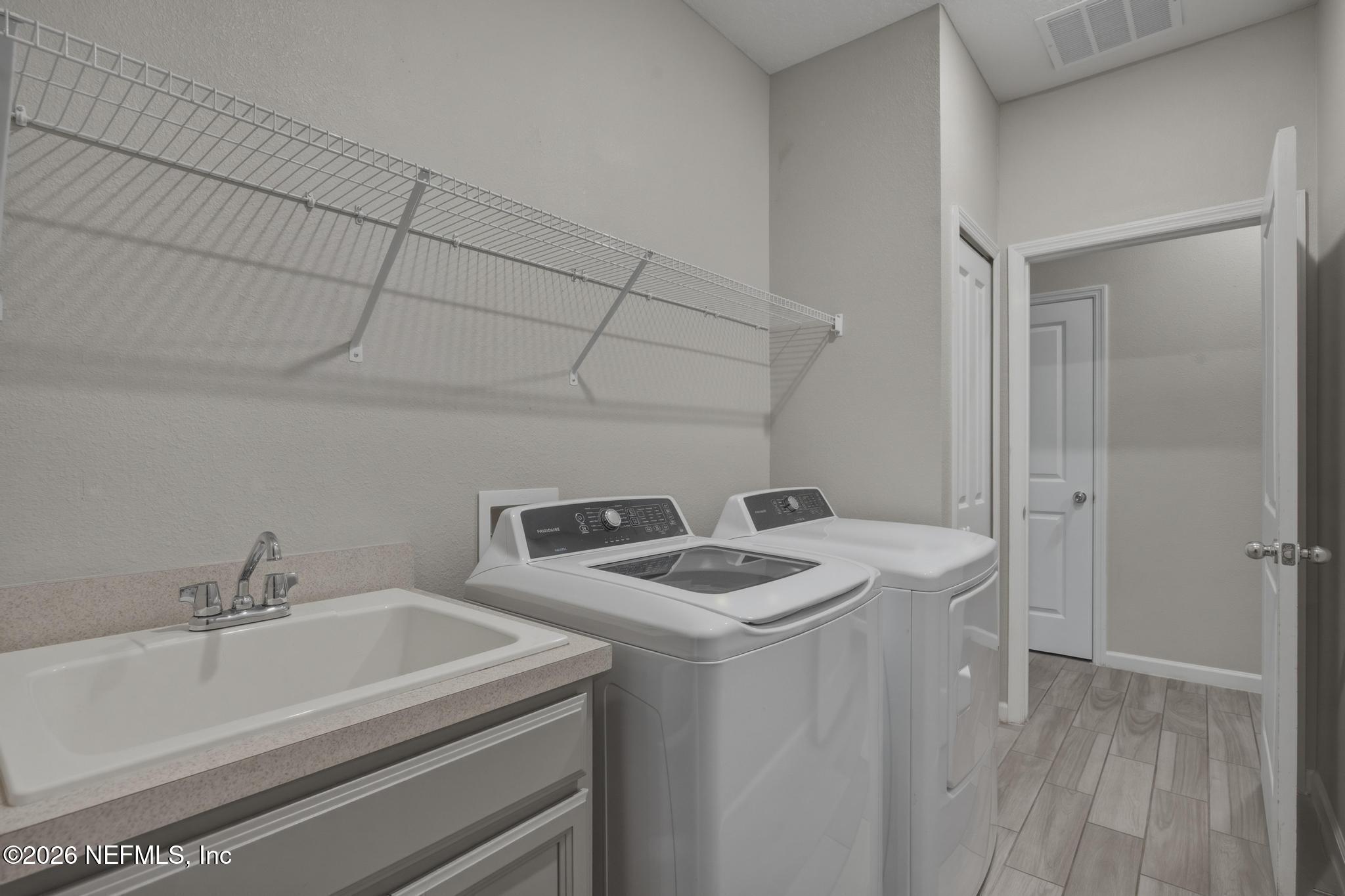 3841 Heatherbrook Place Middleburg, FL 32068 - Photo 28 of 39 a utility room with dryer and washer