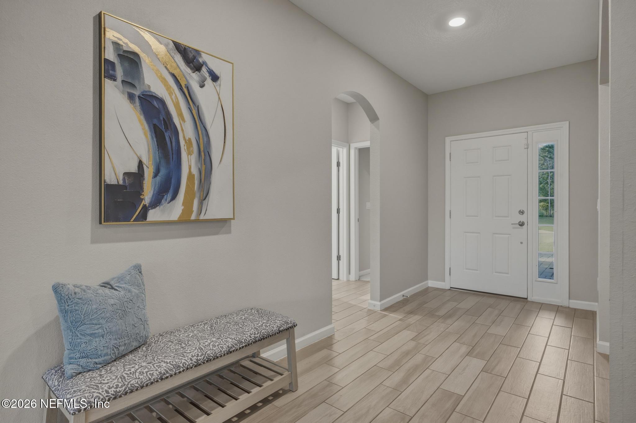 3841 Heatherbrook Place Middleburg, FL 32068 - Photo 3 of 39 a view of a livingroom with wooden floor and a hallway