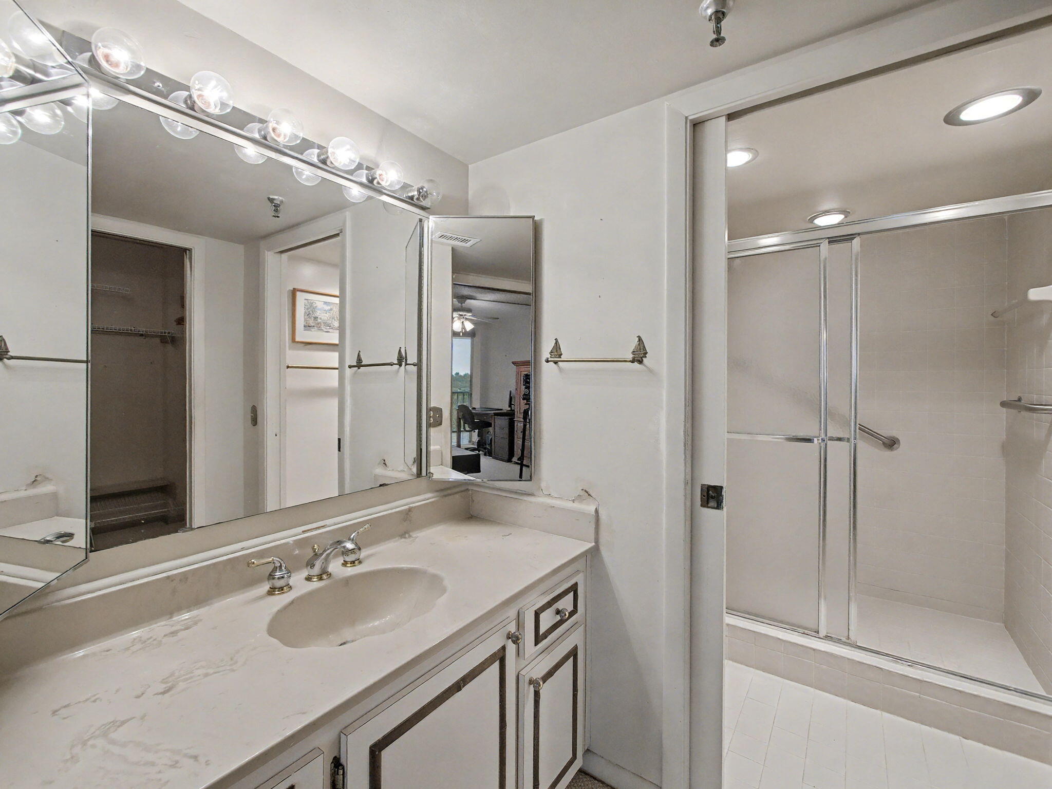 198 Northwest 67th Street, Unit 505 Boca Raton, FL 33487 - Photo 12 of 15 a bathroom with a granite countertop shower sink and mirror