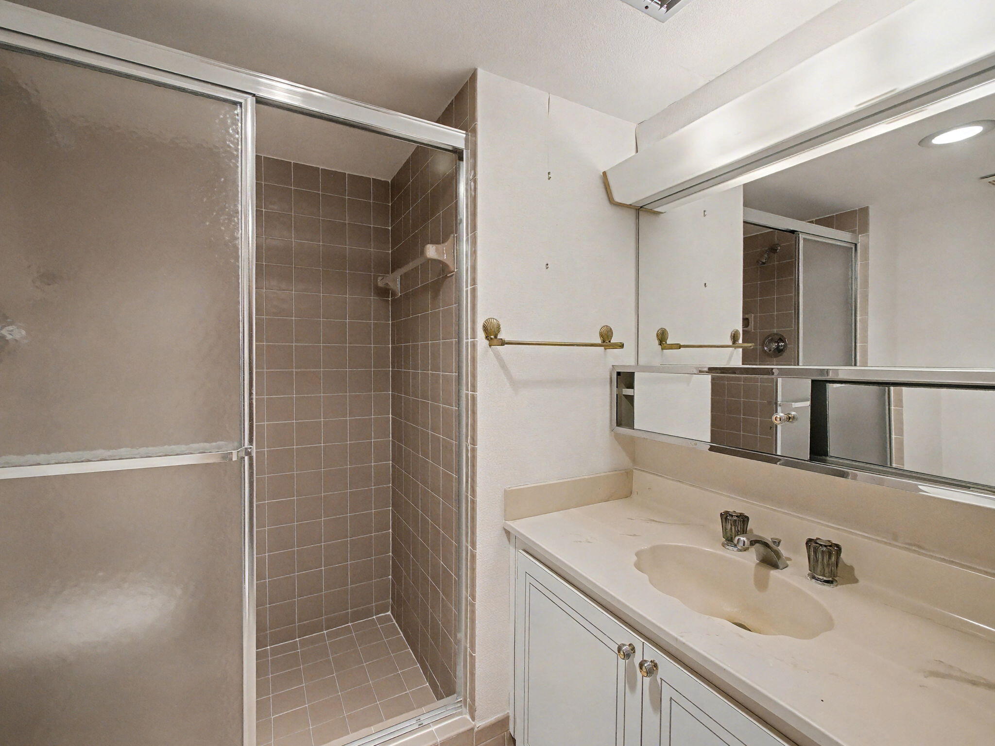 198 Northwest 67th Street, Unit 505 Boca Raton, FL 33487 - Photo 13 of 15 a bathroom with a shower sink and mirror