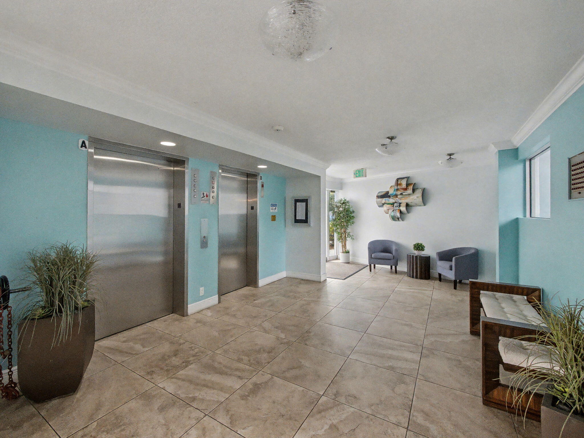 198 Northwest 67th Street, Unit 505 Boca Raton, FL 33487 - Photo 2 of 15 a big room with painting and a potted plant