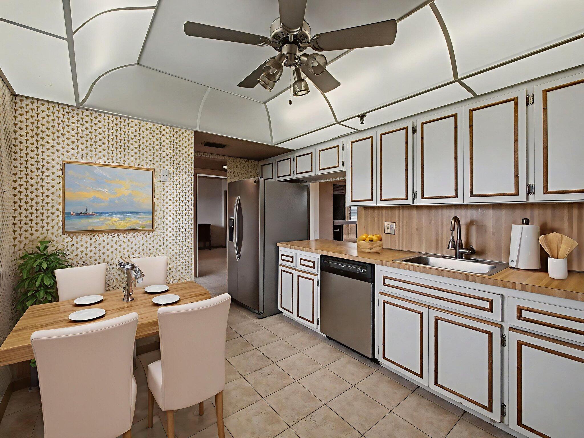 198 Northwest 67th Street, Unit 505 Boca Raton, FL 33487 - Photo 3 of 15 a kitchen with stainless steel appliances granite countertop a sink and cabinets