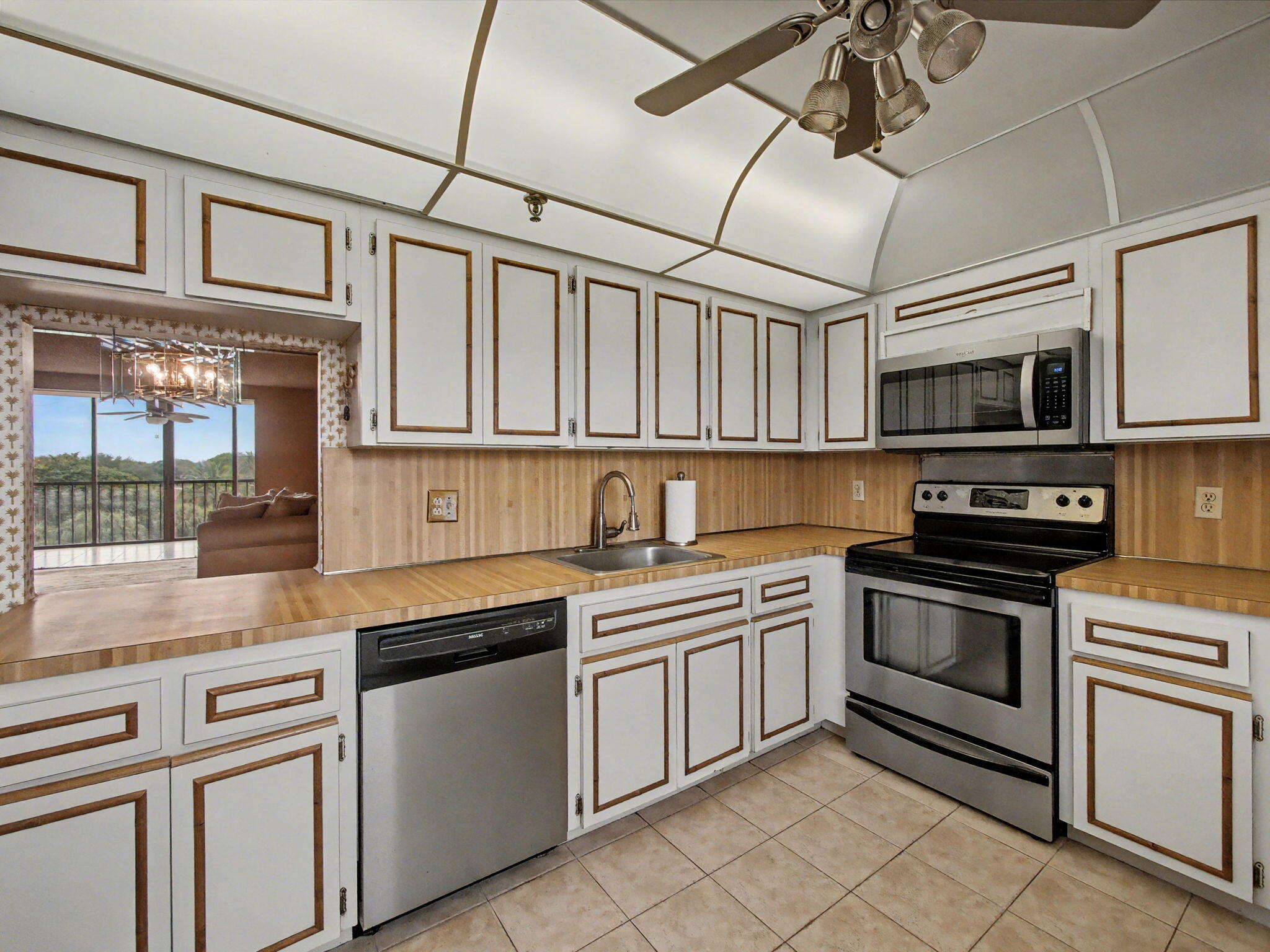 198 Northwest 67th Street, Unit 505 Boca Raton, FL 33487 - Photo 4 of 15 a kitchen with stainless steel appliances granite countertop a stove sink microwave and cabinets