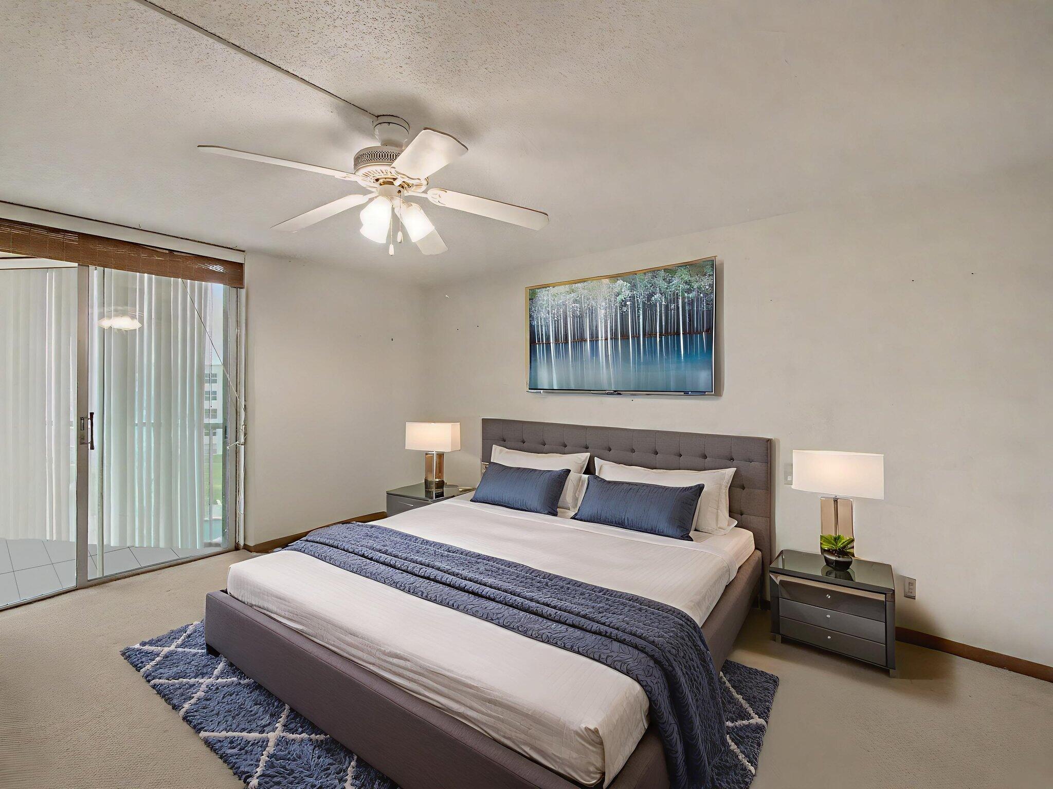 198 Northwest 67th Street, Unit 505 Boca Raton, FL 33487 - Photo 10 of 15 a bedroom with a bed and a painting on the wall