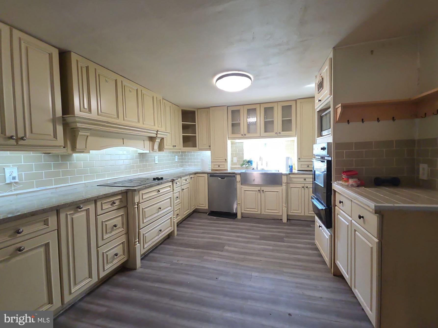44 Highland Avenue Clementon, NJ 08021 - Photo 20 of 37 a kitchen with stainless steel appliances granite countertop wooden cabinets a sink and a stove