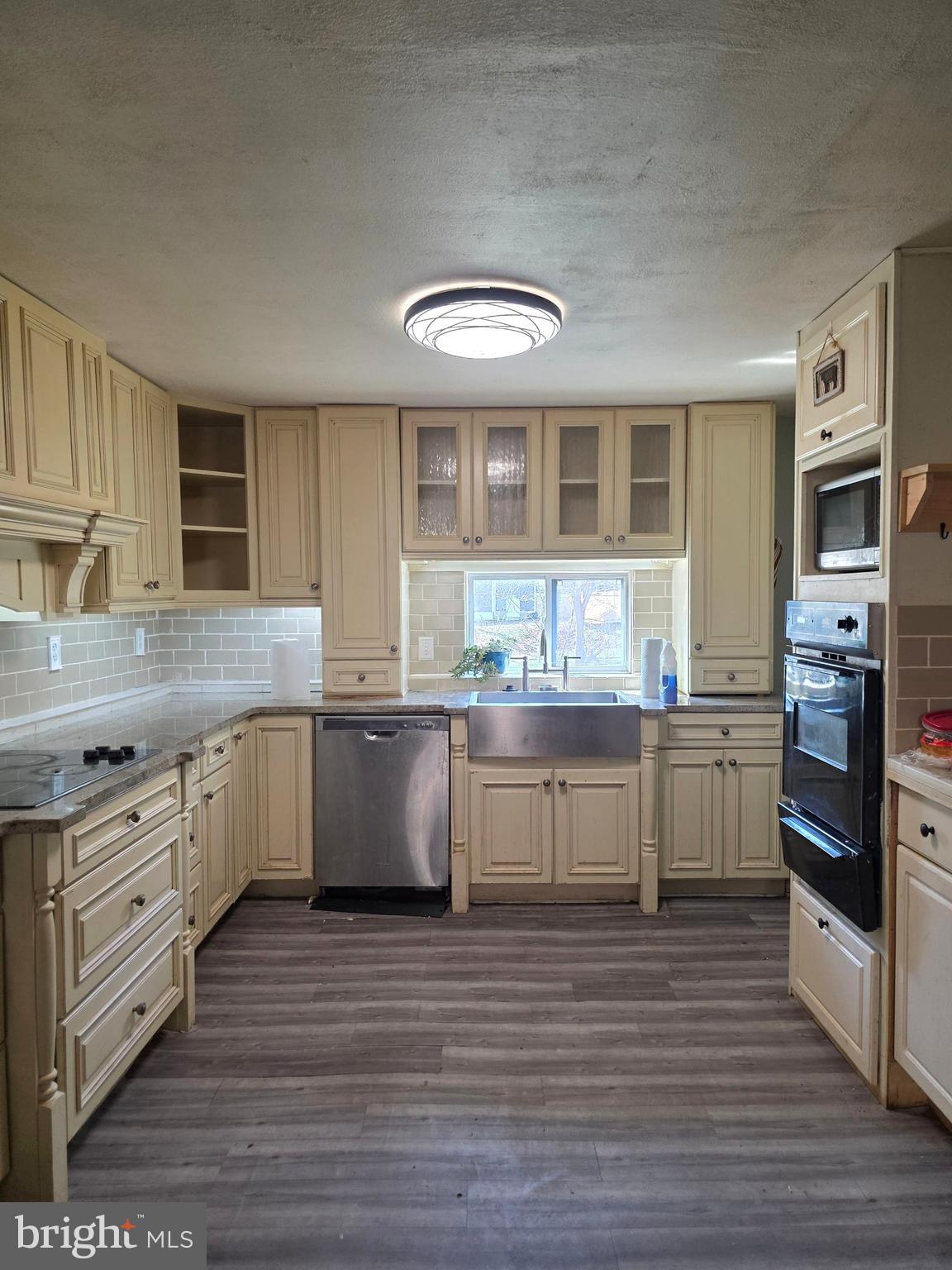 44 Highland Avenue Clementon, NJ 08021 - Photo 21 of 37 a kitchen with granite countertop a stove top oven sink and cabinets