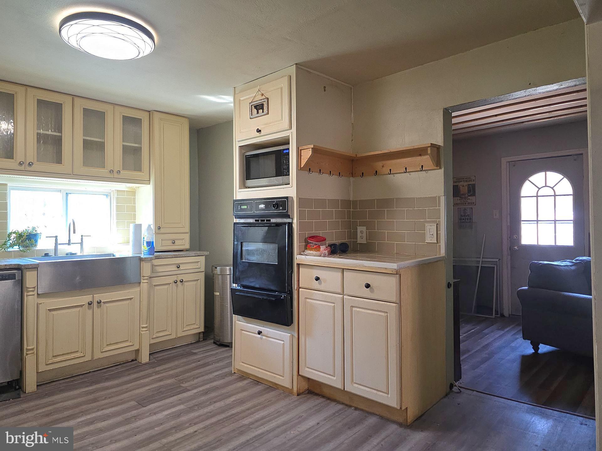 44 Highland Avenue Clementon, NJ 08021 - Photo 23 of 37 a kitchen with stainless steel appliances granite countertop a stove and white cabinets