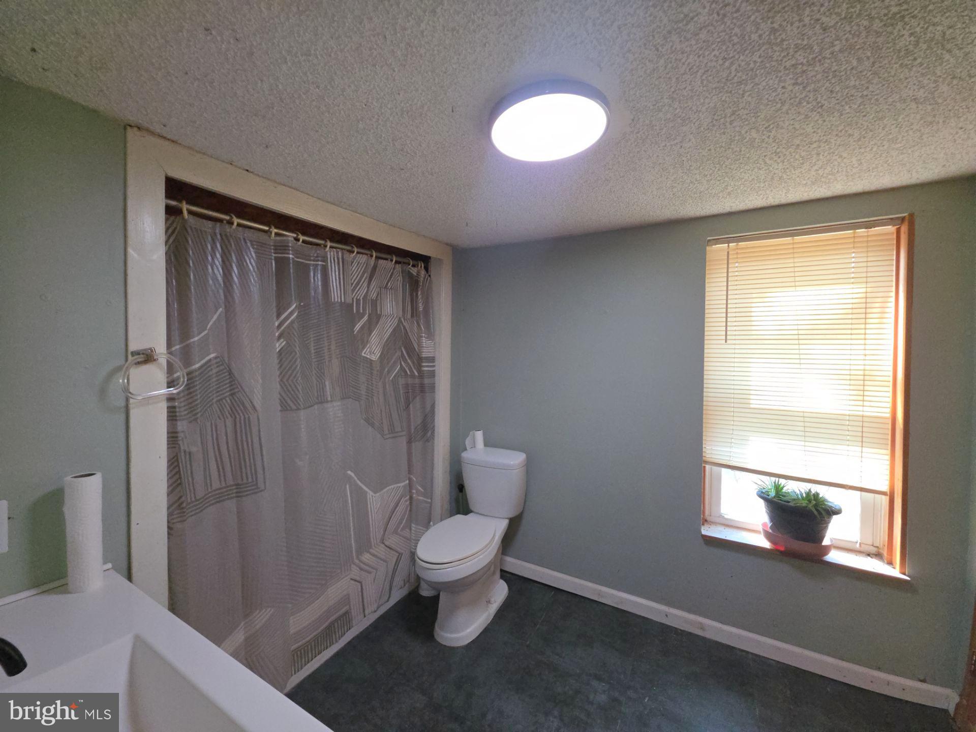 44 Highland Avenue Clementon, NJ 08021 - Photo 31 of 37 a bathroom with a toilet a sink and a shower