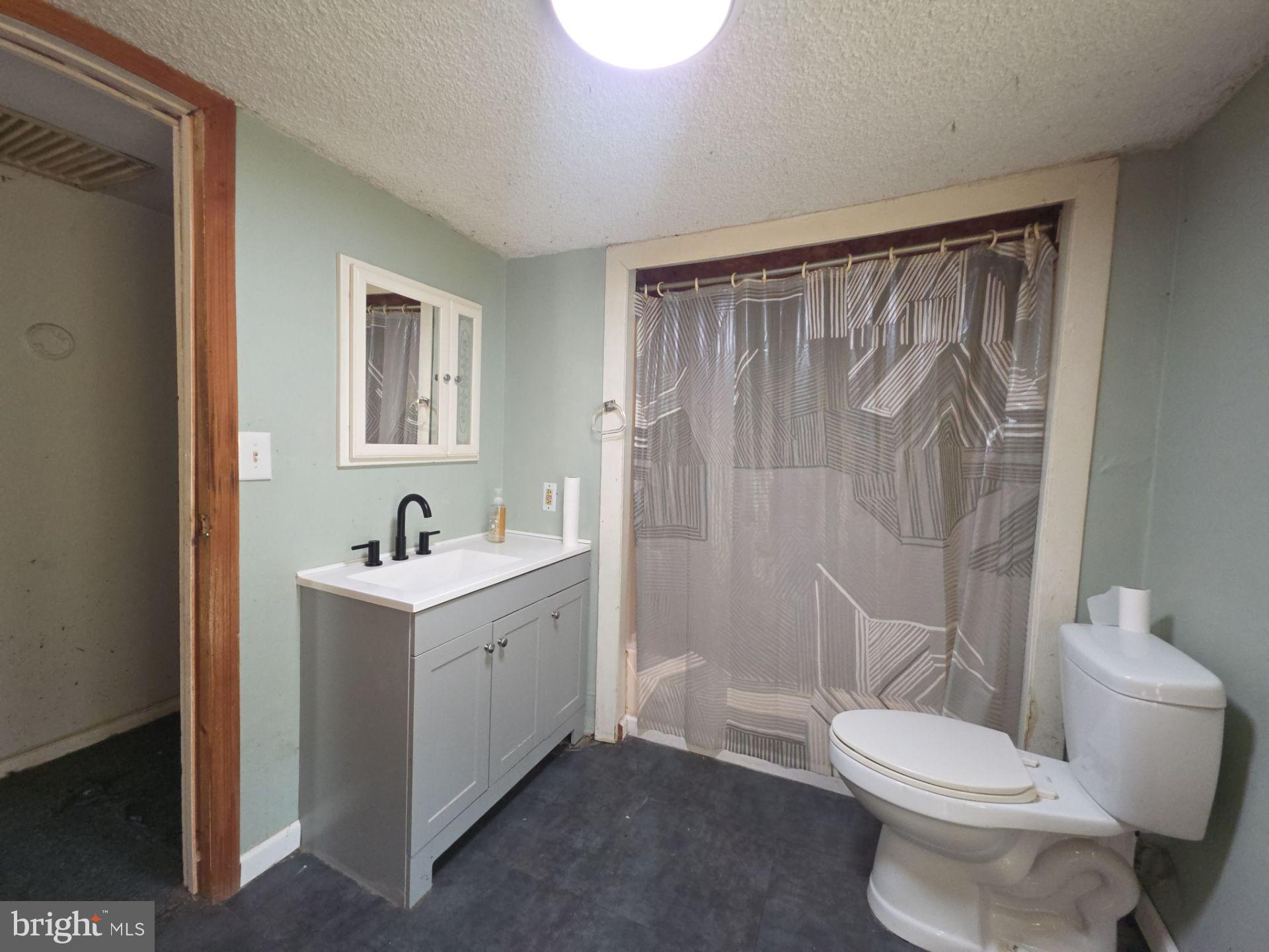 44 Highland Avenue Clementon, NJ 08021 - Photo 33 of 37 a white toilet sitting next to a bathroom sink