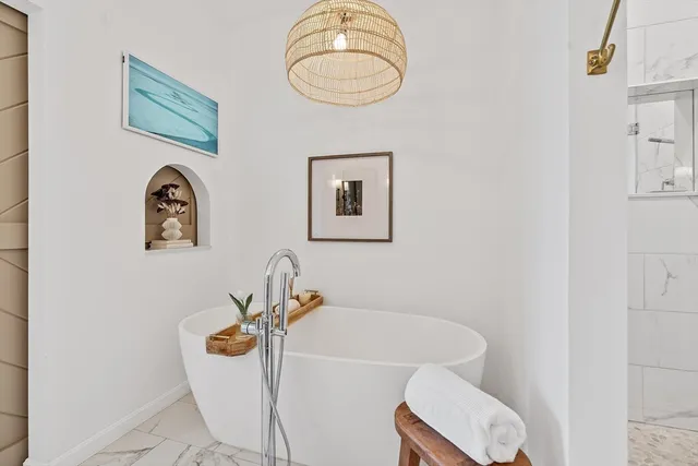 a view of a walk in closet with clothes and shoes