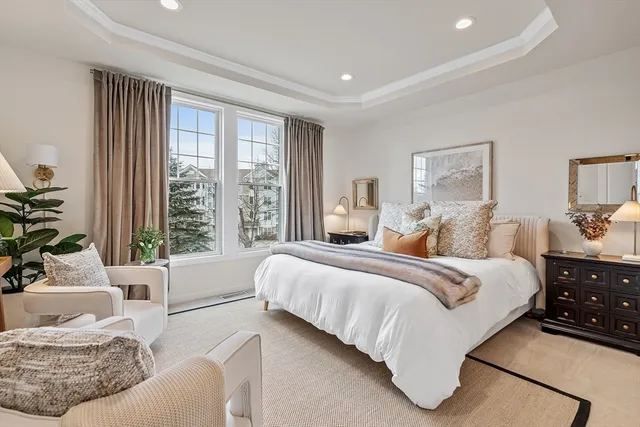 a bedroom with a large bed and a painting on the wall