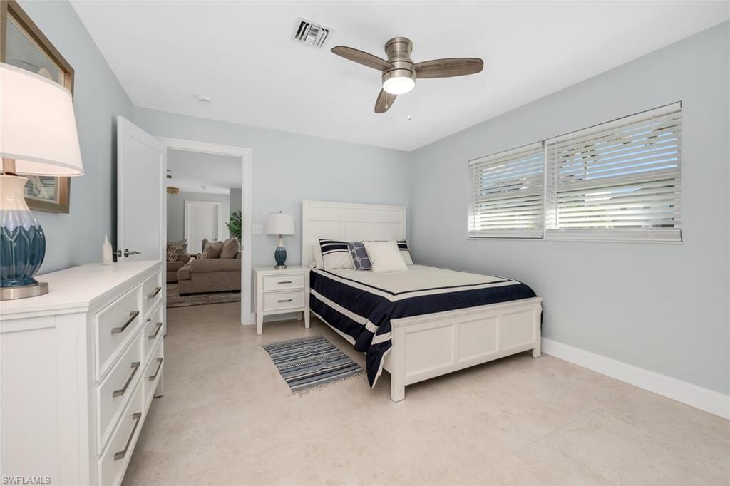 385 Willet Avenue Naples, FL 34108 - Photo 14 of 19 a bedroom with furniture and windows
