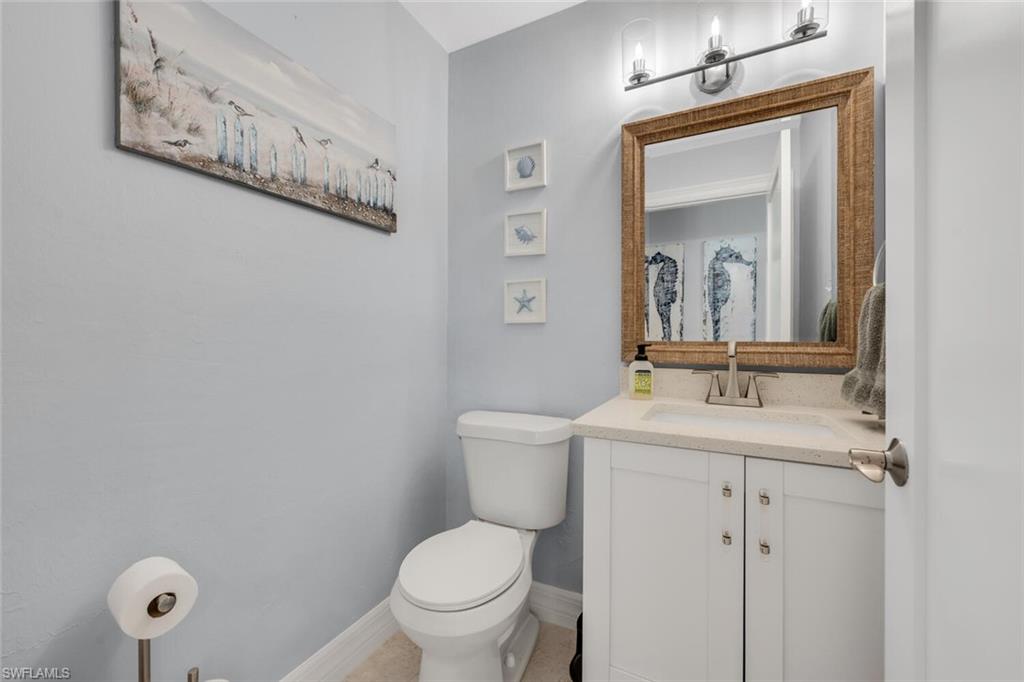 385 Willet Avenue Naples, FL 34108 - Photo 15 of 19 a bathroom with a toilet a sink and mirror