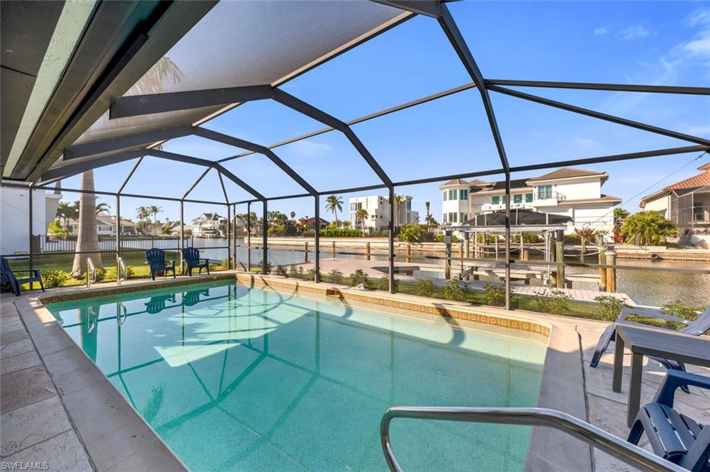 385 Willet Avenue Naples, FL 34108 - Photo 18 of 19 a view of a swimming pool with a patio