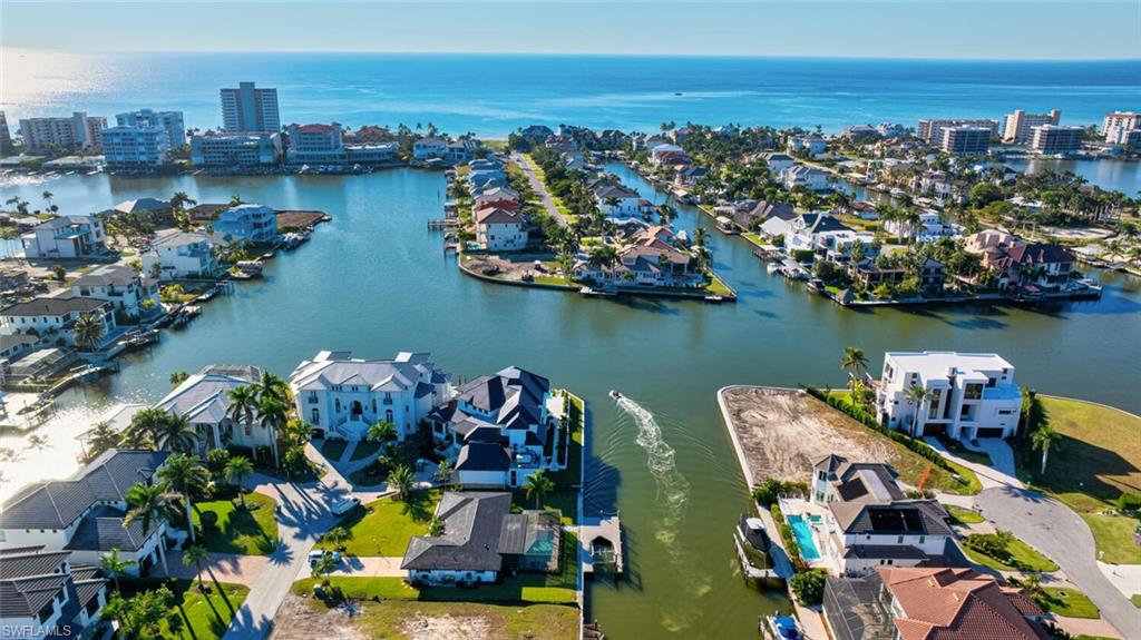 385 Willet Avenue Naples, FL 34108 - Photo 2 of 19 an aerial view of a house with outdoor seating