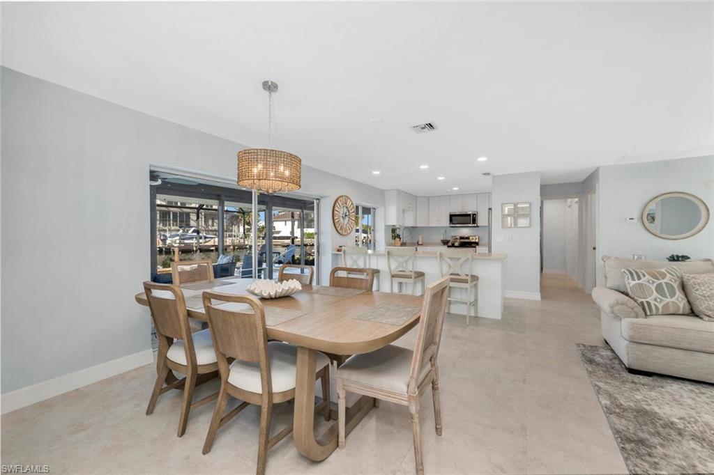 385 Willet Avenue Naples, FL 34108 - Photo 8 of 19 a dining room with furniture and chandelier