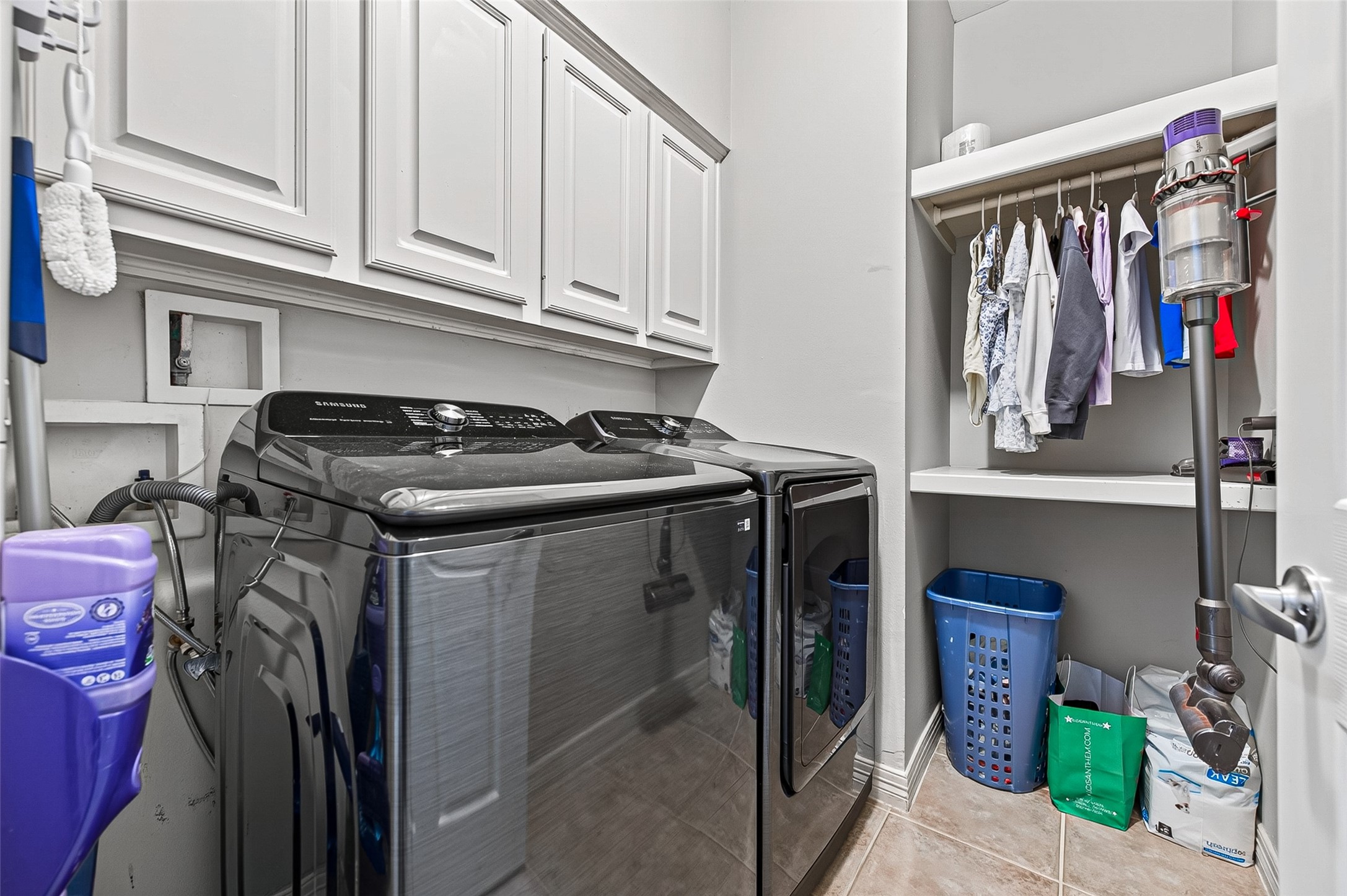 11822 Rue Beaujon Court Tomball, TX 77377 - Photo 20 of 50 A spacious Laundry Room downstairs with cabinetry and shelving.
