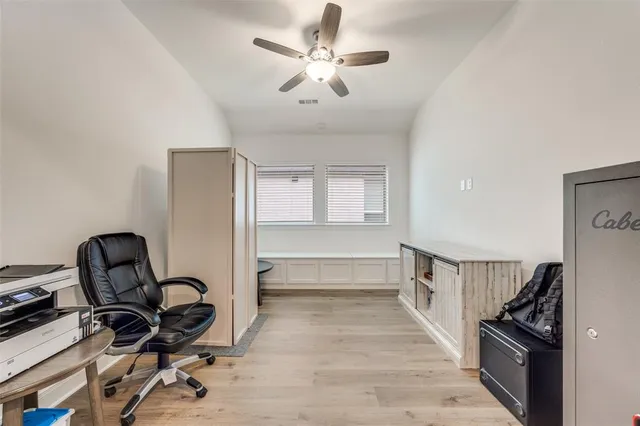 a view of a workspace with furniture and windows