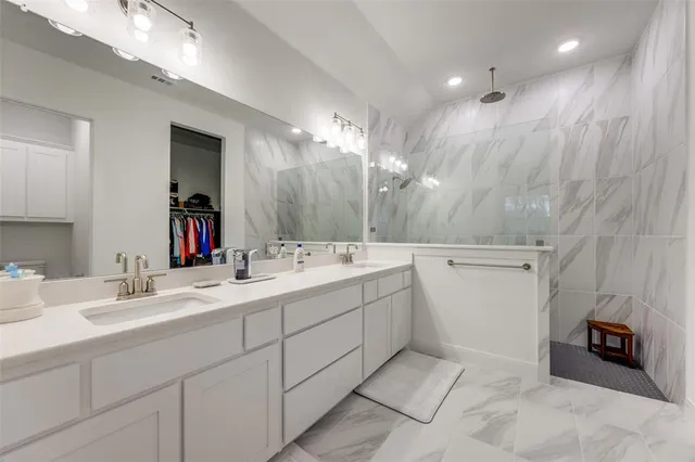 a bathroom with a sink double vanity and a mirror