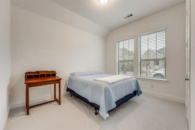 a bed sitting in a room next to a window