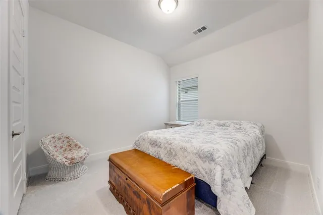 a bedroom with a bed and a lamp