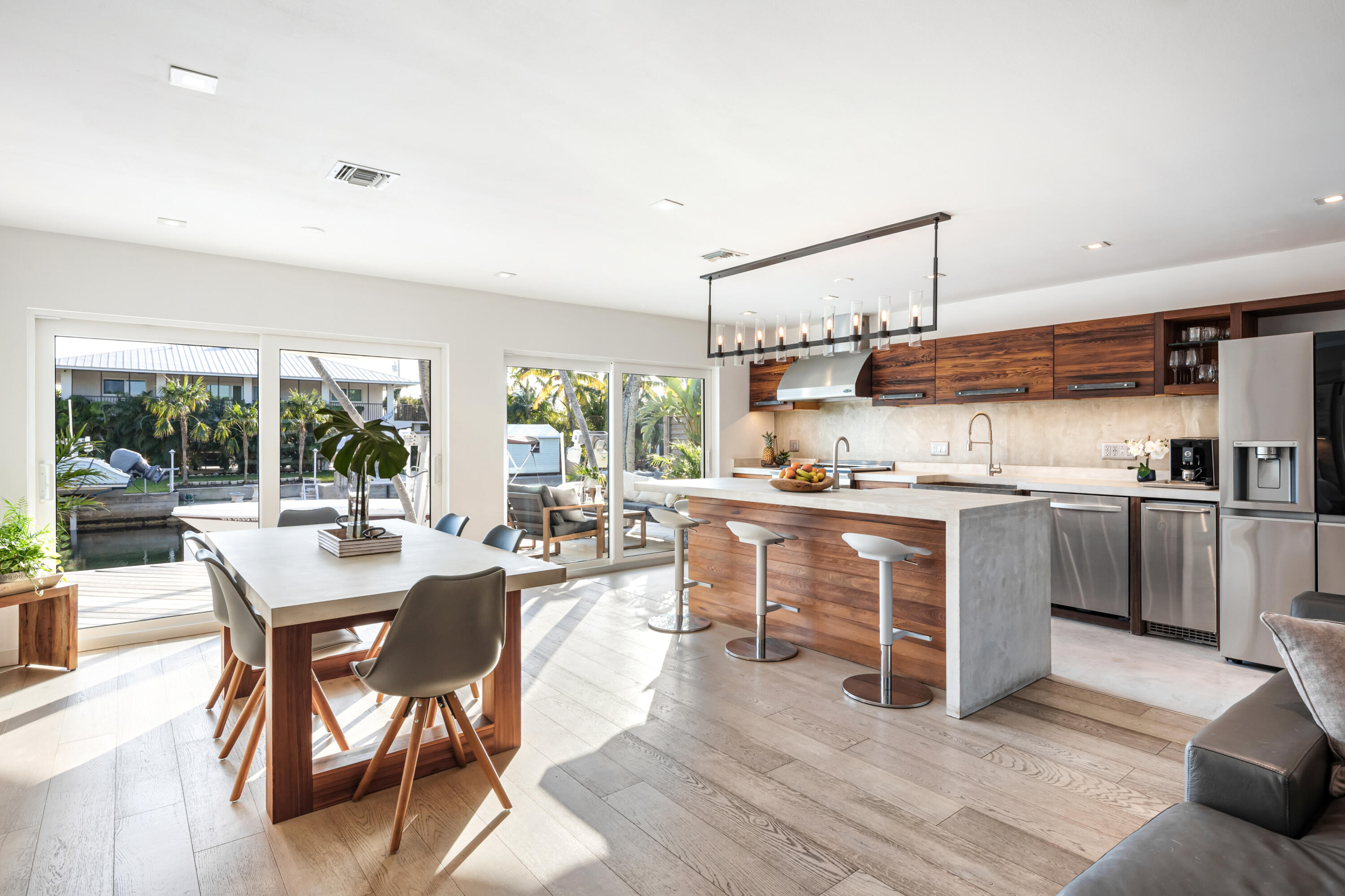 8 Coconut Drive Key West, FL 33040 - Photo 15 of 46 a kitchen with a table chairs microwave and cabinets