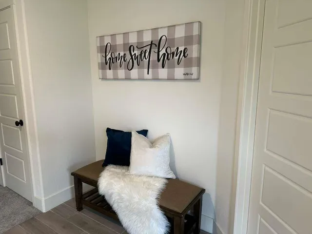 a view of a room with wooden floor and a table