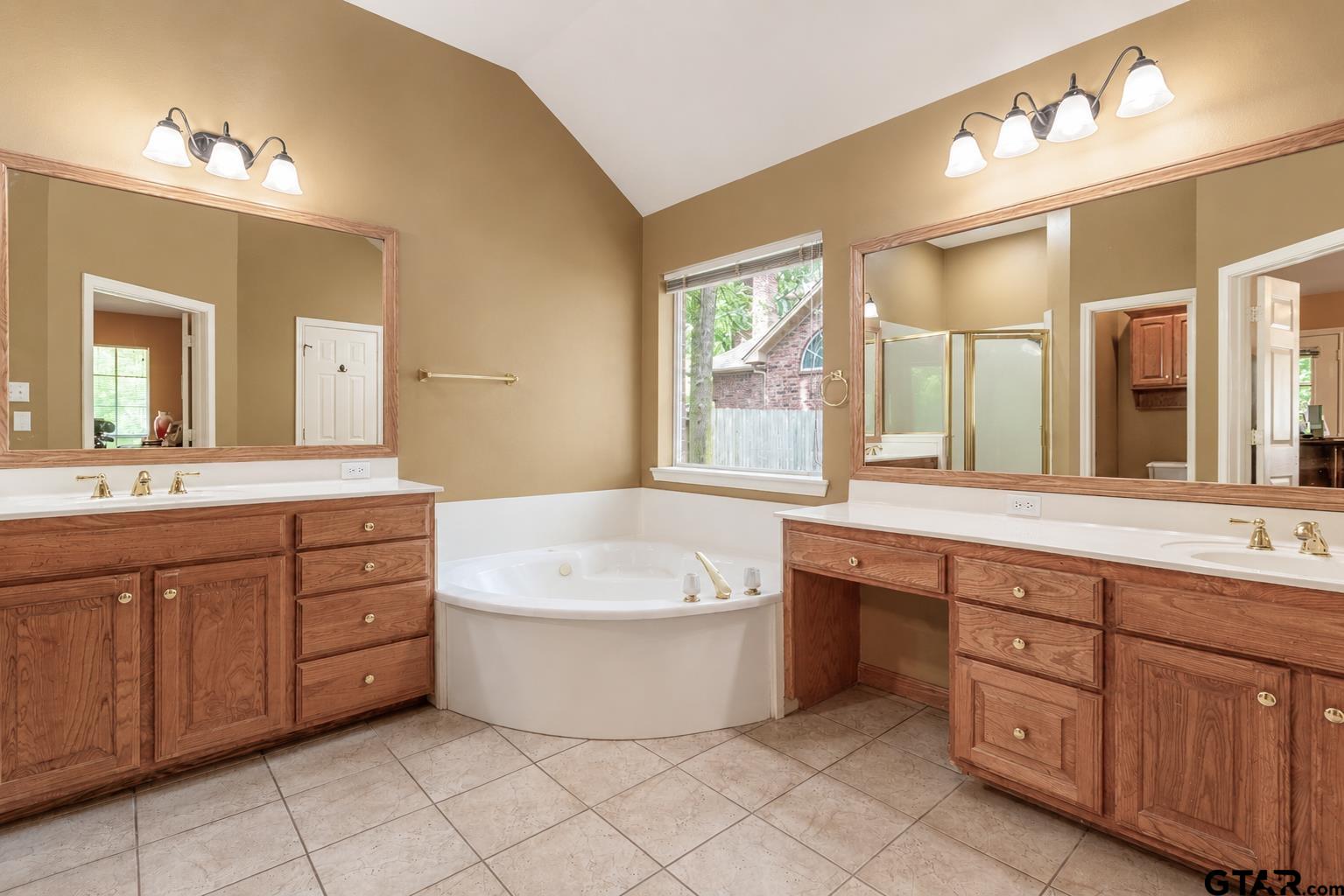 1388 Santa Fe Trail Tyler, TX 75703 - Photo 33 of 46 a spacious bathroom with a tub sink double vanity and mirror