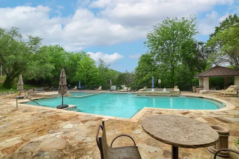a view of a swimming pool and lounge chair
