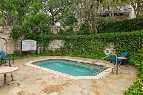 a swimming pool with outdoor seating and yard