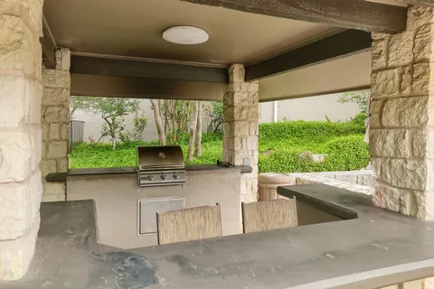 a kitchen with a stove and a large window