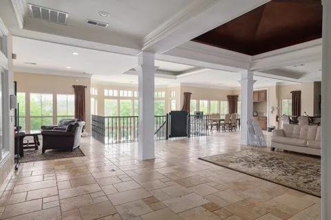a lobby with furniture and floor to ceiling window