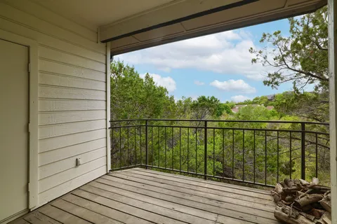 a view of a balcony with wooden floor