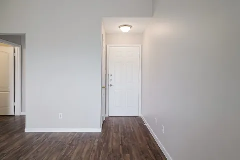 a view of a room with wooden floor
