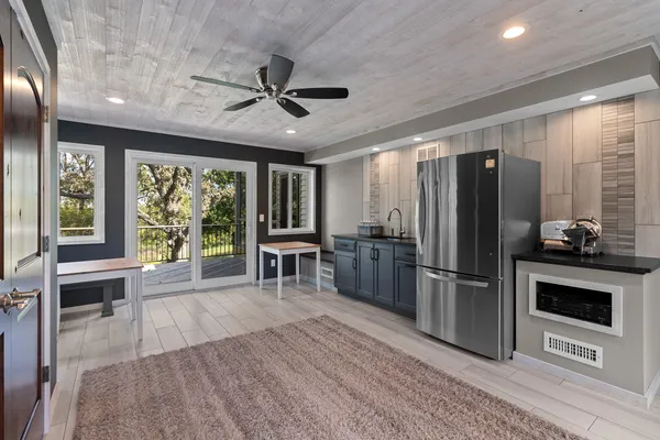 a kitchen with stainless steel appliances granite countertop a refrigerator oven a sink dishwasher and a stove with wooden floor