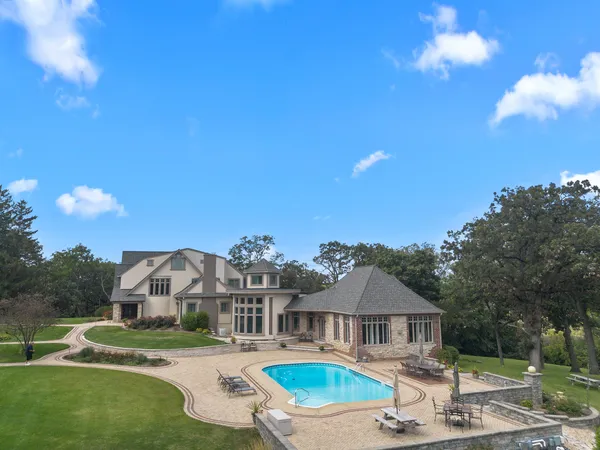 a front view of house with yard entertaining space and outdoor seating