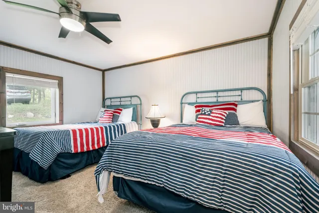 a view of a living room with furniture and floor to ceiling windows