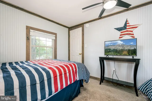 a view of a house with a tree in the background