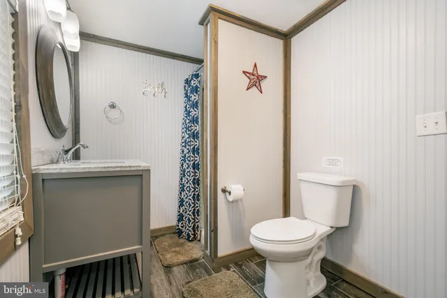 a spacious bedroom with a bed a table and large windows