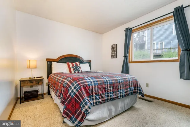 a bedroom with a bed and a night stand