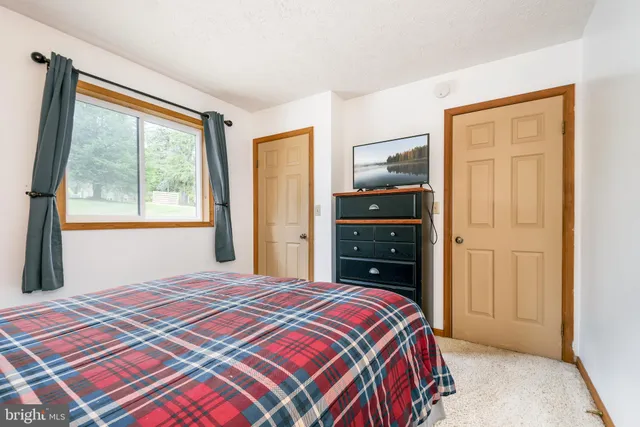 a bedroom with a bed and furniture