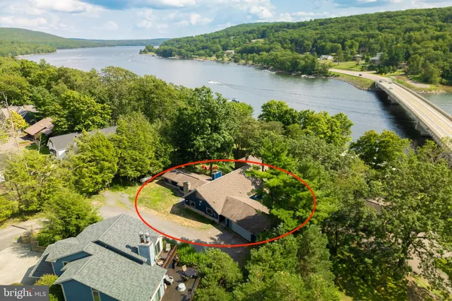 a view of a balcony with floor to ceiling windows and wooden fence