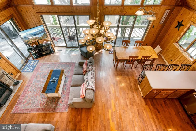 a room with pool table and windows