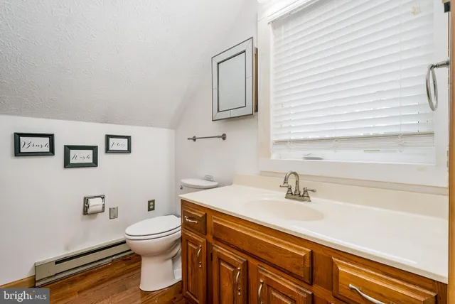 a view of a roof deck with couches and wooden fence